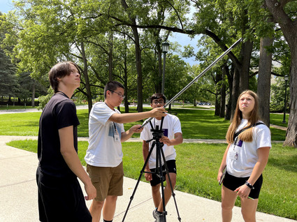 Campers trying to measure MC tower using triangles